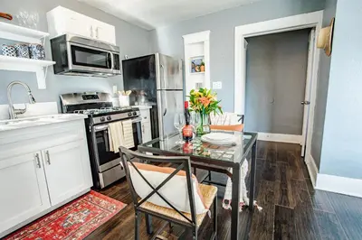 a kitchen with a glass table in a kitchen at People's Choice Central Location Prkg & Patio LBD in Long Beach