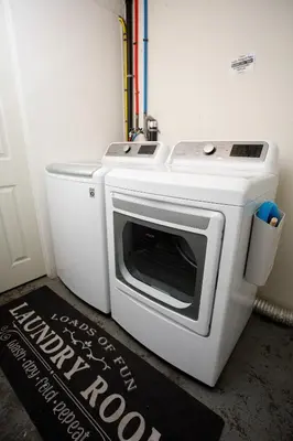 a white toaster oven sitting in the corner of a room at People's Choice Central Location Prkg & Patio LBD in Long Beach