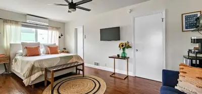 a bedroom with a bed and a tv on the wall at Studio Mins to LAX , Venice Beach & Sony Studios CC B in Los Angeles