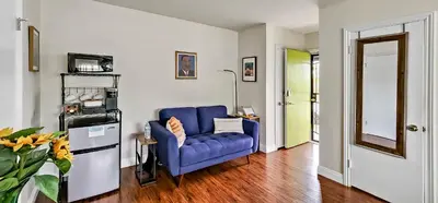 a living room with a blue couch in a room at Studio Mins to LAX , Venice Beach & Sony Studios CC B in Los Angeles