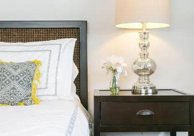 a bed with a nightstand with a lamp and flowers at Top Pick Walk to Restaurants, Shops & Near Beach CC C in Los Angeles