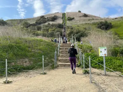 a woman walking up the stairs on a hill at Top Pick Walk to Restaurants, Shops & Near Beach CC C in Los Angeles