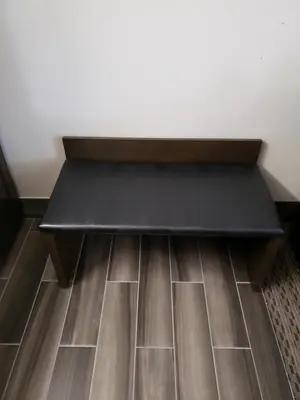 a black bench sitting on top of a floor at Portofino Inn Burbank in Burbank