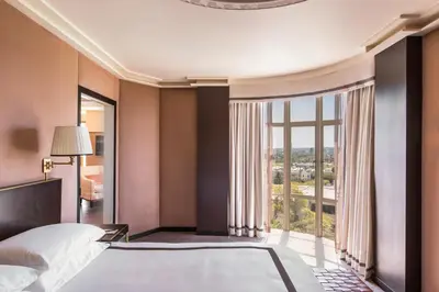 a bedroom with a large bed and a large window at Sunset Tower Hotel in Los Angeles