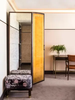a door in a room with a chair and a table at Sunset Tower Hotel in Los Angeles