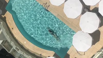 an overhead view of a man in the water in a pool at Sunset Tower Hotel in Los Angeles