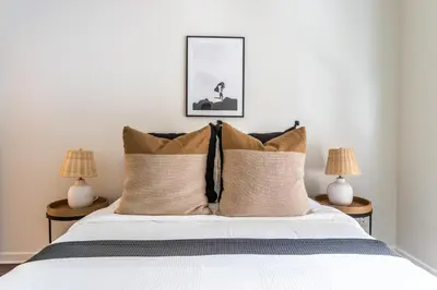 a bedroom with a bed with two lamps at 2BD 2BTH Condo 10 Min Walk to Santa Monica Beach in Los Angeles