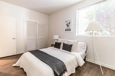 a white bedroom with a large bed and a window at 2BD 2BTH Condo 10 Min Walk to Santa Monica Beach in Los Angeles