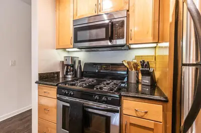 a kitchen with a stove and a microwave at 2BD 2BTH Condo 10 Min Walk to Santa Monica Beach in Los Angeles