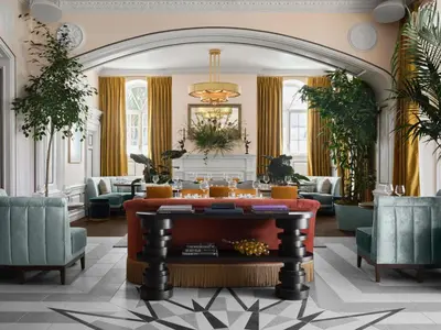 a living room with a couch and a table at The Georgian Hotel in Los Angeles
