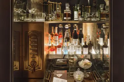 a bar with a lot of bottles of alcohol at The Georgian Hotel in Los Angeles