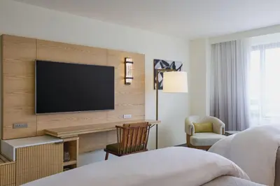 a hotel room with a television on a wall at The Westin Los Angeles Airport in Los Angeles