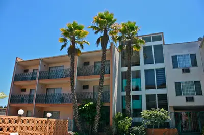 a building with palm trees in front of it at Royal Century Hotel at LAX in Inglewood