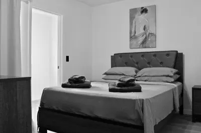 a black and white photo of a bed in a room at Renovateed Two-Bedroom Apartment in Santa Monica in Los Angeles