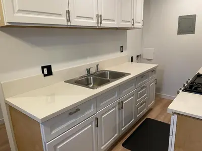 a kitchen with white cabinets and a sink at Renovateed Two-Bedroom Apartment in Santa Monica in Los Angeles