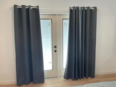 a pair of black curtains in front of a window at Renovateed Two-Bedroom Apartment in Santa Monica in Los Angeles