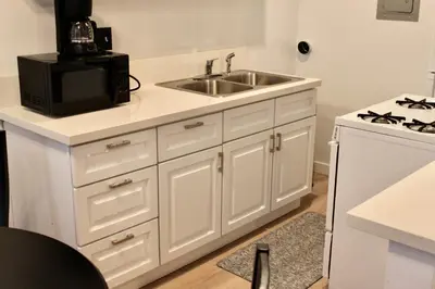 a kitchen with a sink and a microwave at Charming Apartment in Santa Monica