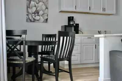 a kitchen with black chairs and a table at Charming Apartment in Santa Monica