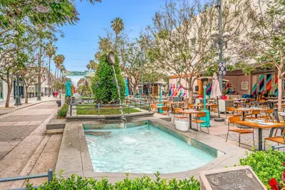 a swimming pool with a fountain in a park at Charming Apartment in Santa Monica