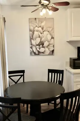 a dining room table and chairs with a painting on the wall at Charming Apartment in Santa Monica