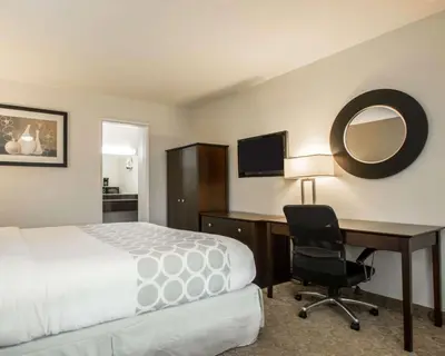 a hotel room with a bed and a desk and a chair at Rodeway Inn Convention Center in Los Angeles
