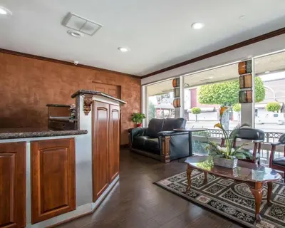 a kitchen and living room with a couch and a table at Rodeway Inn Convention Center in Los Angeles