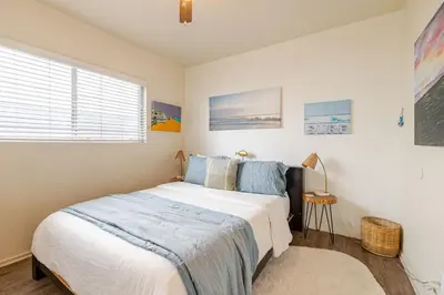 a bedroom with a bed and a window at Oceanfront Oasis in Long Beach