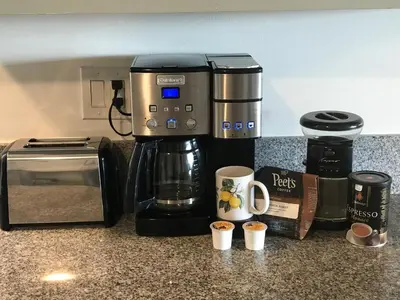 a coffeemaker sitting on a counter with coffee cups at Oceanfront Oasis in Long Beach