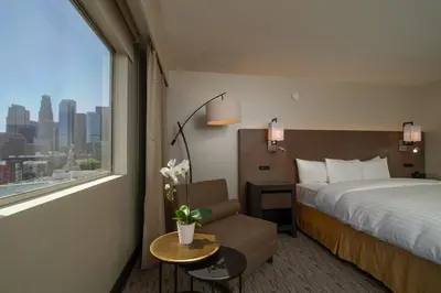 a hotel room with a bed and a window at Miyako Hotel Los Angeles in Los Angeles