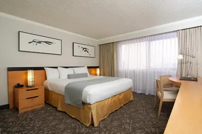 a hotel room with a large bed and a desk at Miyako Hotel Los Angeles in Los Angeles