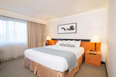a hotel room with a large bed and a window at Miyako Hotel Los Angeles in Los Angeles