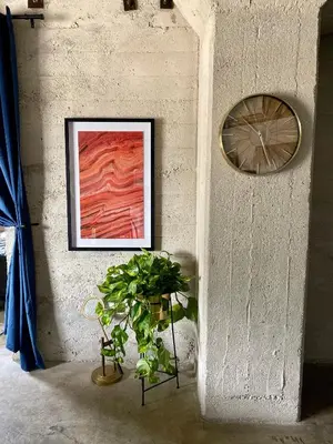 a wall with a clock and a potted plant at THE MIDNIGHT LOFT BY BOBOU DESIGN (KING SUITE) in Los Angeles