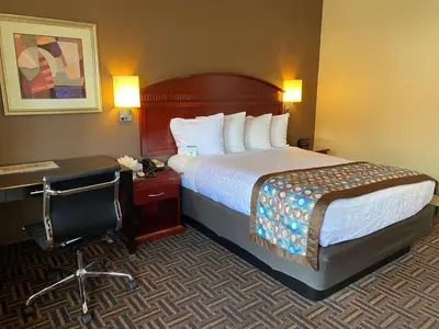 a hotel room with a bed and a desk at Best Western Pasadena Inn in Pasadena