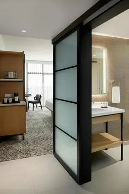 a sliding glass door in a room with a bathroom at Sheraton Park Hotel at the Anaheim Resort in Anaheim