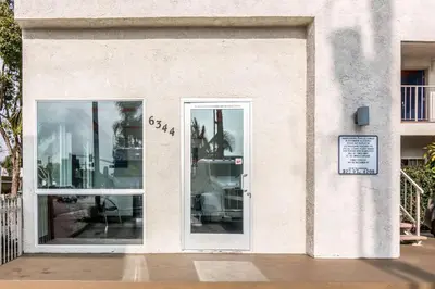 a store front with doors and a sign on it at Motel 6 Bell Gardens, CA - Los Angeles in Bell Gardens