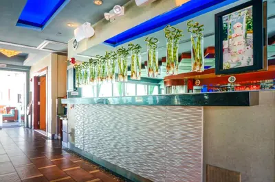 a bar in a restaurant with gold chandeliers at Shade Hotel Manhattan Beach in Manhattan Beach