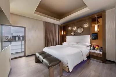 a bedroom with a large white bed and a window at Shade Hotel Manhattan Beach in Manhattan Beach