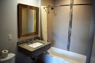 a bathroom with a sink and a shower at Deluxe Inn Hawthorne/ LAX in Hawthorne
