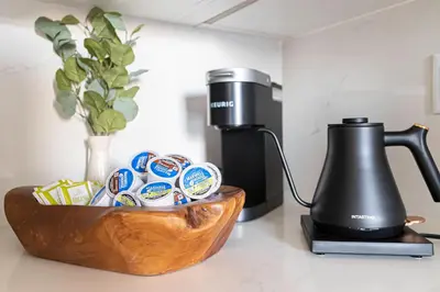 a black coffee maker and a wooden bowl with food at Fashion Loft 2 bedroom Downtown in Los Angeles