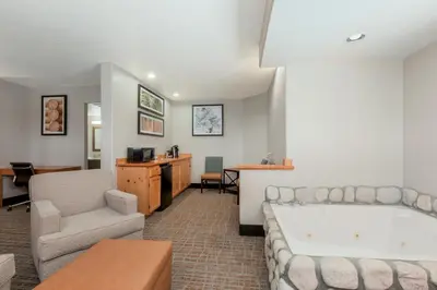 a living room with a tub and a couch and a table at Holiday Inn Resort The Lodge at Big Bear Lake by IHG in Big Bear Lake