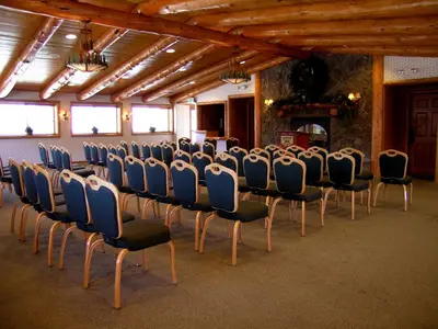 a row of chairs in a room with a fireplace at Holiday Inn Resort The Lodge at Big Bear Lake by IHG in Big Bear Lake