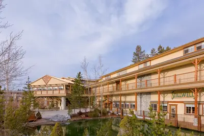 a large building with a pond in front of it at Holiday Inn Resort The Lodge at Big Bear Lake by IHG in Big Bear Lake