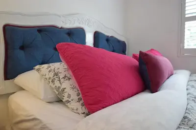a bunch of pillows sitting on top of a bed at Venice Beach Apartments Monthly rents in Los Angeles