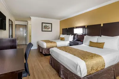 a hotel room with two beds and a table at Best Western Plus South Bay Hotel in Lawndale