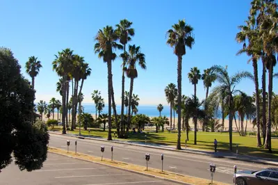 a street with palm trees and the ocean at Bayside Hotel in Los Angeles