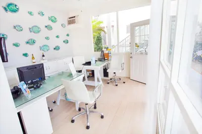 an office with a desk with a computer and chairs at Bayside Hotel in Los Angeles