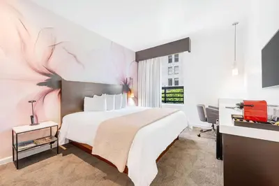 a hotel room with a large bed and a desk at The O Hotel, Trademark Collection by Wyndham in Los Angeles