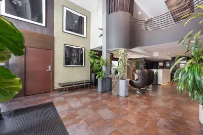 a lobby with plants and a waiting room at The O Hotel, Trademark Collection by Wyndham in Los Angeles