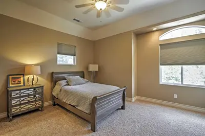 a bedroom with a bed and a ceiling fan at Roomy Home with Deck, 5 Mi to Lake Arrowhead Village in Lake Arrowhead