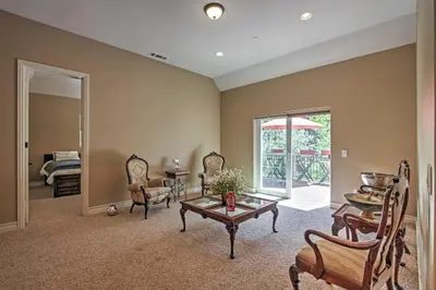a living room with a table and chairs at Roomy Home with Deck, 5 Mi to Lake Arrowhead Village in Lake Arrowhead